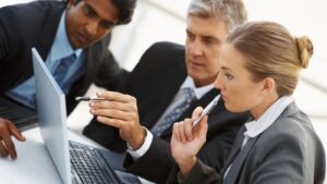 IT Service Consultants looking at computer